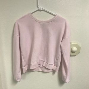 A baby pink crop top sweater